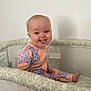 Piper joined the competition — help win amazing prizes! baby, child, cute, face, foot, happy, head, indoor, infant, light_skin, mesh, pajamas, patterned, person, playpen, purple_cats, sitting, smiling, tongue_out, wall