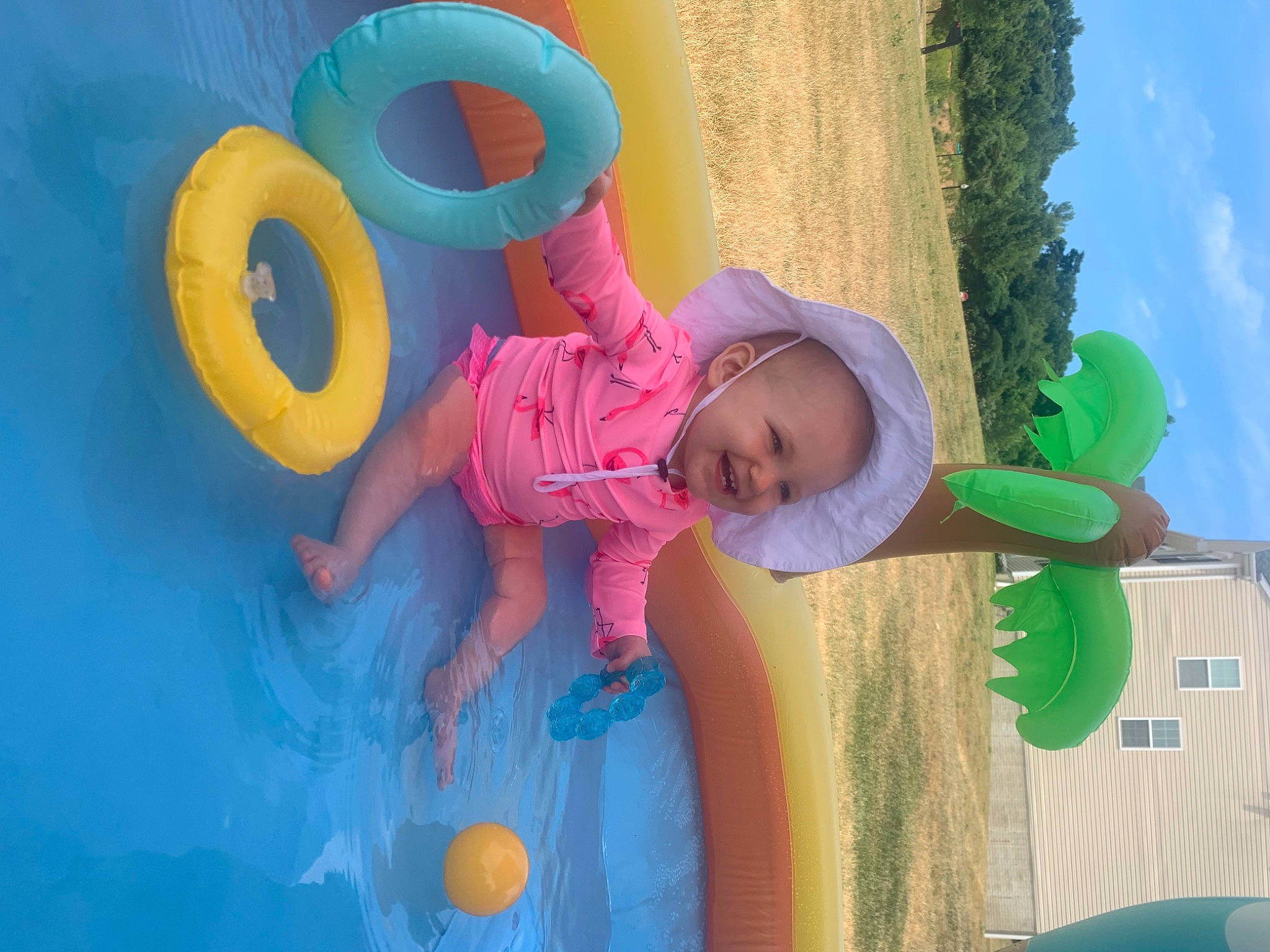 Sophia joined the competition — help win amazing prizes! azure, baby_toddler_clothing, blue, cloud, fun, grass, green, happy, hat, joy, leisure, outdoor_play_equipment, people_in_nature, person, pink, public_space, recreation, sky, sun_hat, tire