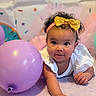 baby, infant, child, balloon, headband, golden_bow, curly_hair, white_clothing, blanket, celebration, party, colorful, cute, portrait, indoor, smiling, happy, face, hand, toddler