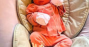 Julie is registered to the contest to win money with this photo: baby, baby_seat, baby_shoes, child, comfortable, cozy, cushion, cute, headband, indoor, infant, mittens, newborn, person, pink_clothing, portrait, resting, small, soft_fabric, young