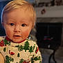 child, toddler, face, blond_hair, pajamas, holiday, christmas, trees, red_truck, indoor, home, cozy, curious, rosy_cheeks, portrait, close_up, cute, person, smiling, baby