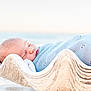 baby, sleeping, blanket, seashell, beach, sand, ocean, knitted, blue, peaceful, infant, portrait, soft_focus, nature, outdoor, cute, serene, resting, child, newborn
