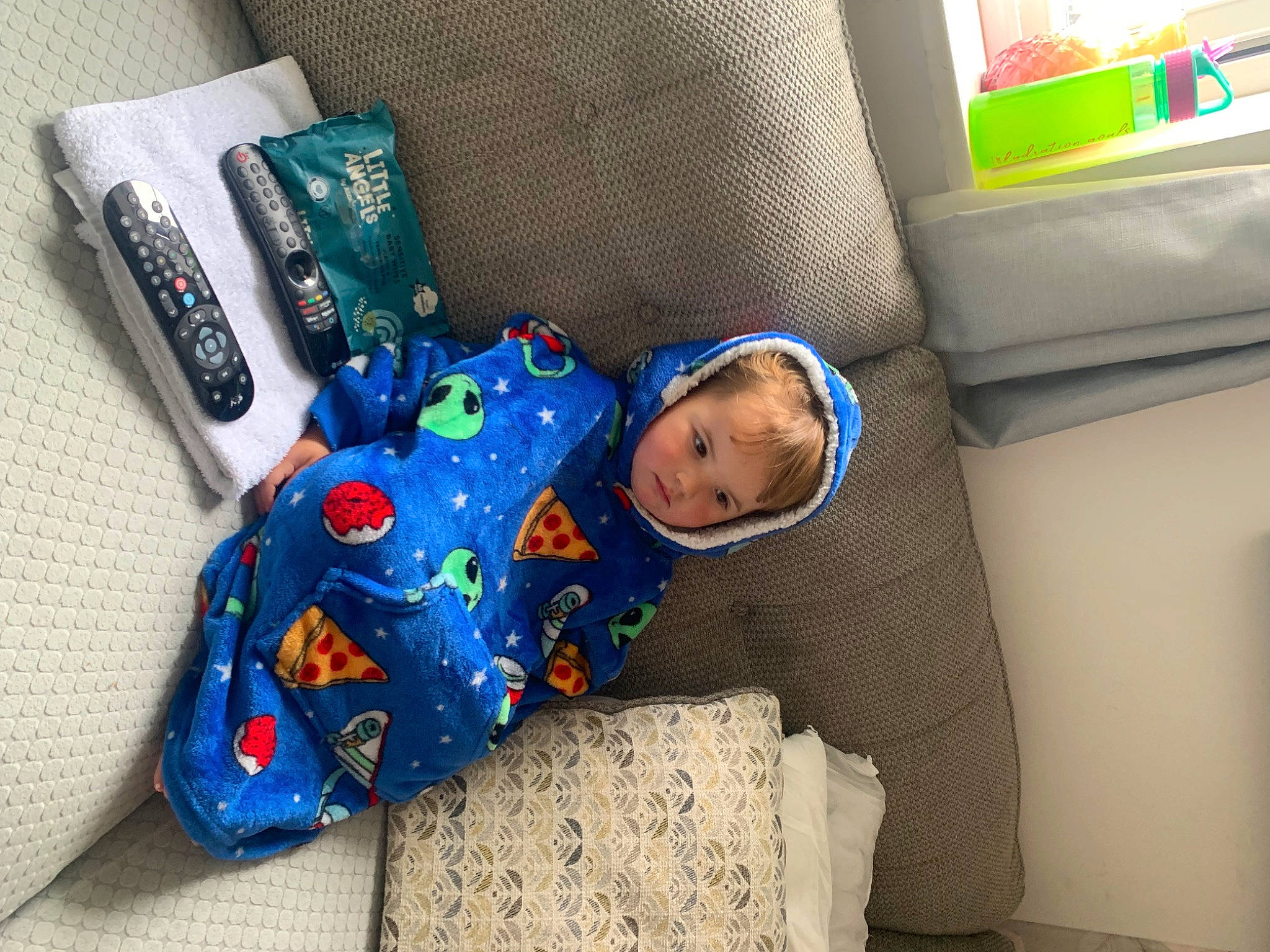 Harvey is registered to the contest to win money with this photo: baby, baby_products, baby_toddler_clothing, baby_toys, bag, child, comfort, couch, electric_blue, flooring, linens, pattern, person, plastic, play, product, room, sitting, t_shirt, toddler