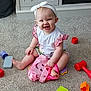 baby, child, smiling, sitting, toys, carpet, headband, bow, pink, white, happy, play, floor, cute, indoor, clothing, infant, person, toddler, colorful