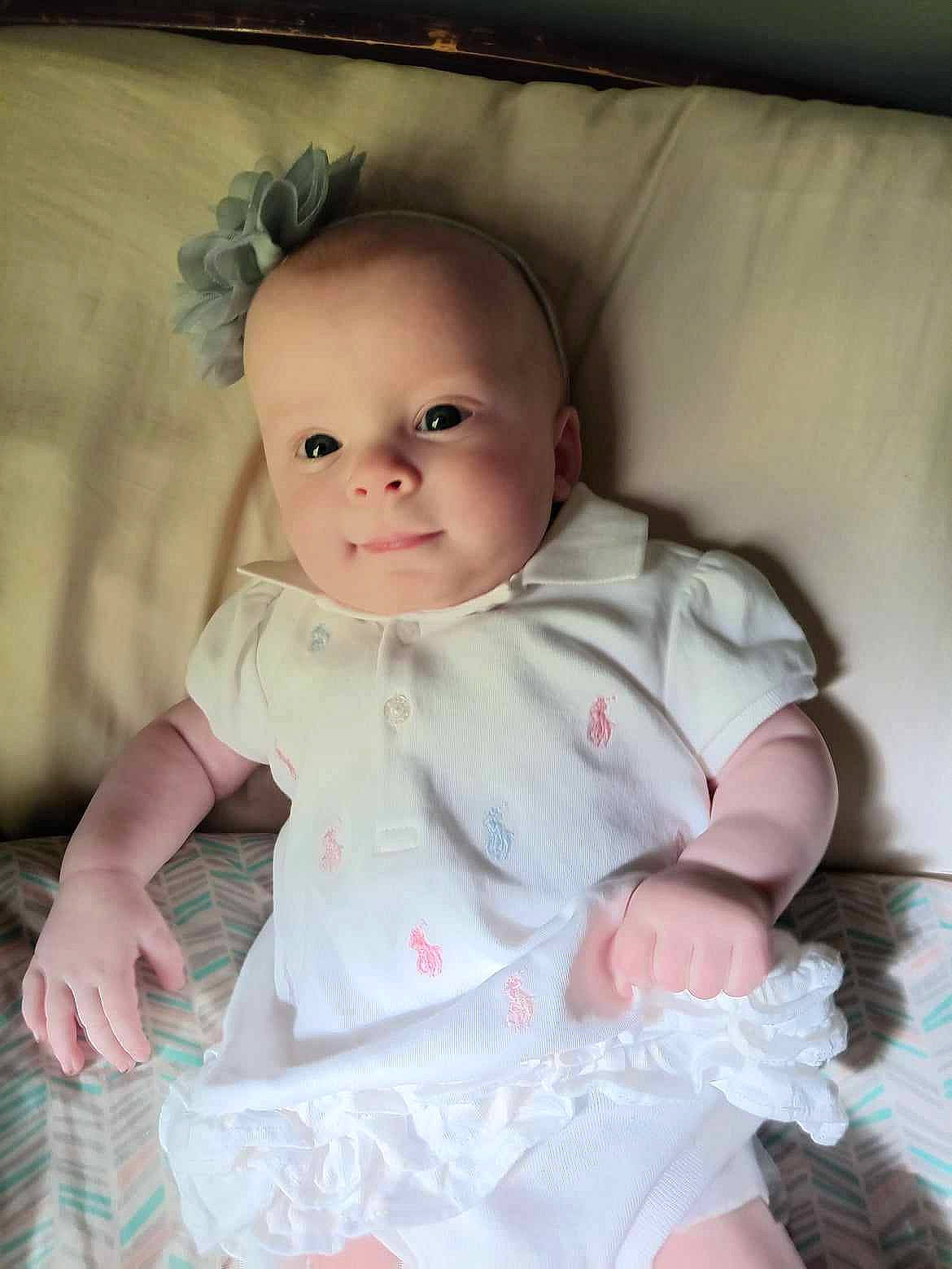 Ellianna is registered to the contest to win money with this photo: baby, baby_toddler_clothing, cheek, child, collar, comfort, day_dress, dress, eye, face, flash_photography, happy, iris, lip, person, pink, sitting, skin, sleeve, smile