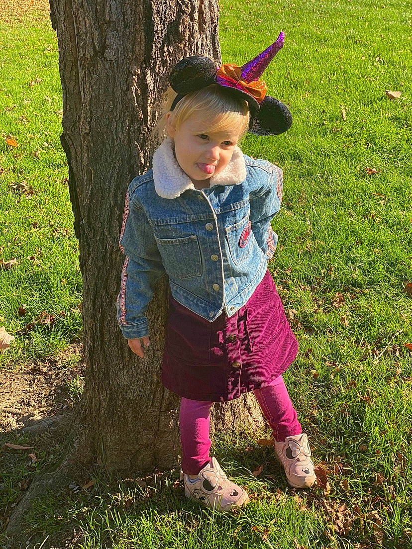 Layanna is registered to the contest to win money with this photo: baby_toddler_clothing, boot, child, fun, grass, grassland, happy, jacket, leisure, magenta, pattern, people_in_nature, person, plant, play, sitting, soil, sunlight, toddler, tree