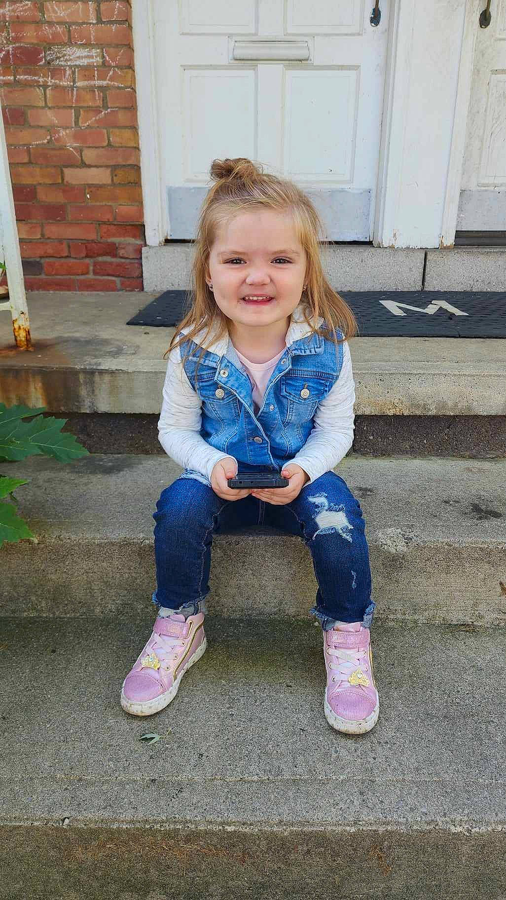 Ryleigh is registered to the contest to win money with this photo: baby_toddler_clothing, clothing, denim, electric_blue, eye, fun, grass, hair, hairstyle, happy, head, human_body, jeans, joy, knee, outerwear, person, purple, sleeve, smile