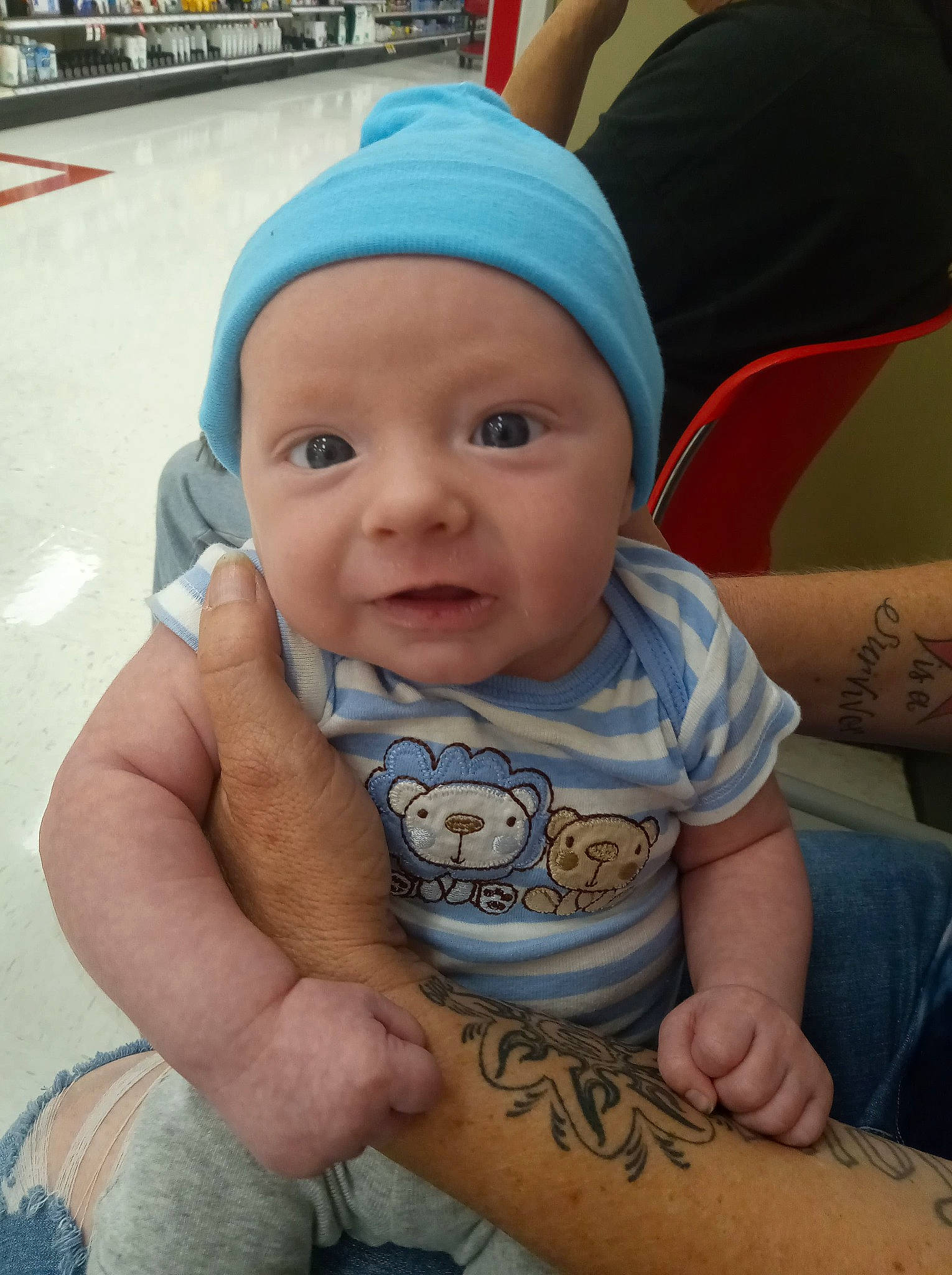 Hunter is registered to the contest to win money with this photo: abdomen, baby, baby_toddler_clothing, baseball_cap, blue, cap, cheek, chest, child, elbow, fun, happy, hat, headwear, human_leg, joint, person, sitting, skin, sleeve