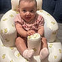 Eliana joined the competition — help win amazing prizes! baby, infant, child, pink_clothing, inflatable_chair, yellow_bear_pattern, socks, smiling, tongue_out, floor, indoor, cute, seated, playful, person, happy, young_child, home, comfort, soft_lighting