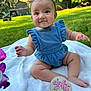 baby, blanket, blue_clothing, bracelet, child, cute, eight_months, grass, greenery, hair_bow, infant, nature, outdoor, portrait, romper, sitting, smiling, toy_atv, wooden_sign, yard
