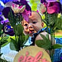 Eliana joined the competition — help win amazing prizes! baby, blanket, blue_clothing, blurred_foreground, celebration, child, closeup, colorful, cute, face, flowers, grass, greenery, infant, nature, outdoor, portrait, ruffles, spring, sunlight