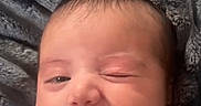 Eliana joined the competition — help win amazing prizes! baby, blanket, closeup, clothing, comfort, cozy, cute, expression, face, head, indoors, infant, newborn, portrait, skin, sleepwear, smiling, soft_texture, warm, winking