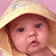 Lottie joined the competition — help win amazing prizes! baby, infant, face, hood, yellow_towel, soft_texture, close_up, portrait, curious, cute, skin, eyes, mouth, pink_background, child, newborn, expression, warmth, indoors, wrapped