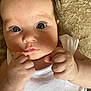 Lottie joined the competition — help win amazing prizes! baby, infant, face, hands, white_clothing, closeup, skin, eyes, curious, soft_texture, fingers, portrait, cute, child, newborn, expression, natural_light, small_fists, lying_down, indoors