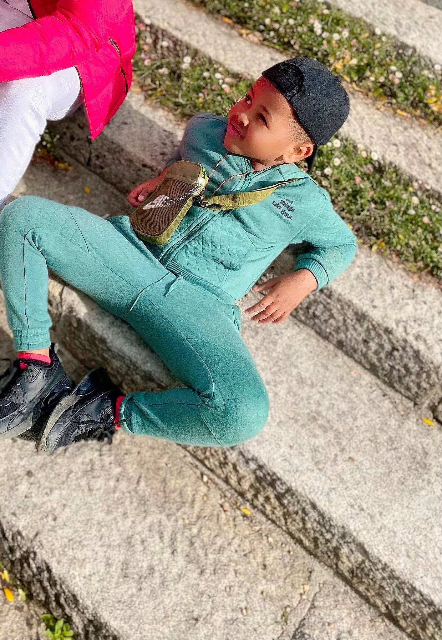 Dimitri Kayss participe au concours pour gagner de l'argent avec cette photo : bag, baseball_cap, cap, child, denim, electric_blue, grass, happy, headwear, human_body, human_leg, joy, leisure, luggage_and_bags, person, recreation, shoe, sitting, sneakers, street_fashion