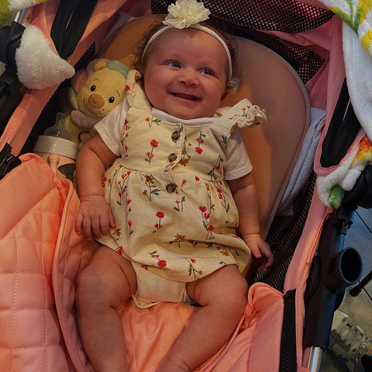 Mireya joined the competition — help win amazing prizes! baby, baby_bottle, blanket, child, clothing, comfort, cute, feet, flower, hand, happy, headband, indoor, infant, legs, pink, plush_toy, portrait, smiling, stroller