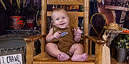 Weston joined the competition — help win amazing prizes! baby, child, rocking_chair, wooden_chair, brown_outfit, fish_patch, smiling, indoor, rustic, fishing_theme, fishing_net, lantern, wooden_floor, sign, plants, hat, bucket, happy, portrait, crawling_steps
