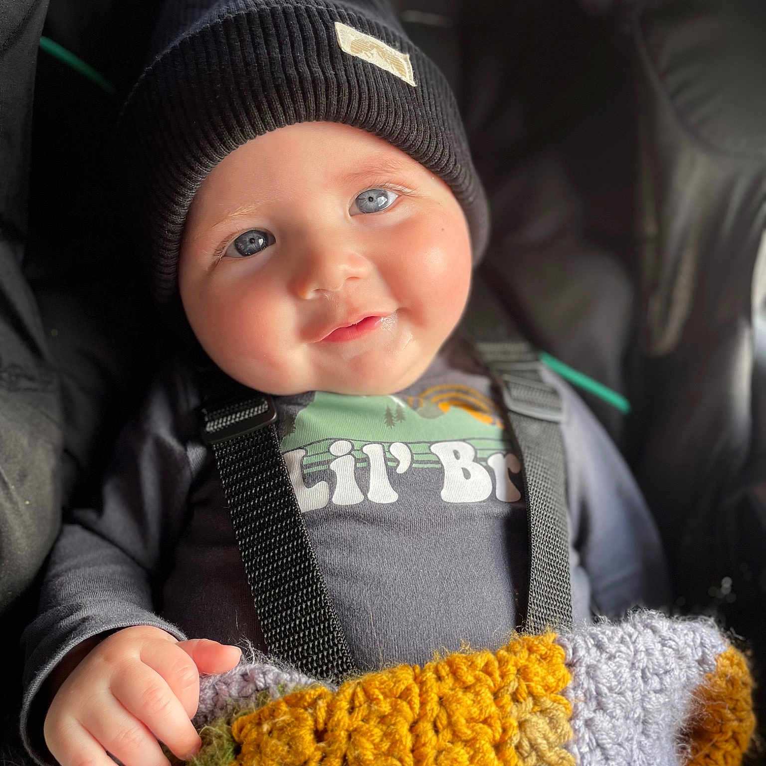 Weldon is registered to the contest to win money with this photo: baby, baby_products, baby_toddler_clothing, cap, cheek, child, comfort, facial_expression, fashion_accessory, knit_cap, organ, outerwear, people_in_nature, skin, sleeve, smile, textile, toddler, wool, woolen
