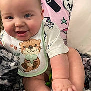 Alexander joined the competition — help win amazing prizes! baby, infant, smile, chubby_cheeks, bib, otter_design, blanket, lipstick_pattern, stars, cute, happy, cozy, soft_texture, hand, foot, clothing, indoors, portrait, child, person