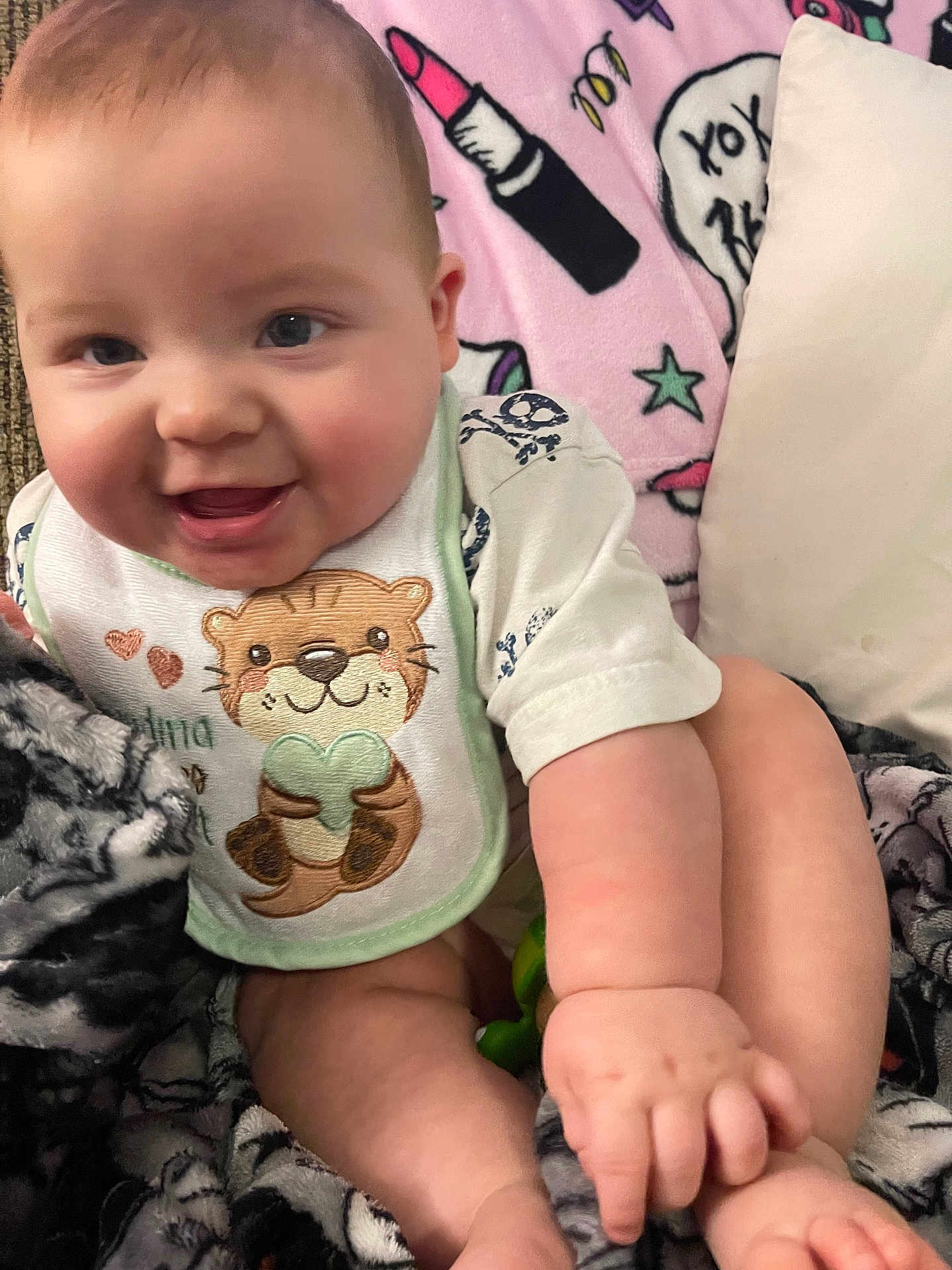 Alexander joined the competition — help win amazing prizes! baby, infant, smile, chubby_cheeks, bib, otter_design, blanket, lipstick_pattern, stars, cute, happy, cozy, soft_texture, hand, foot, clothing, indoors, portrait, child, person