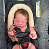 Phoenix is registered to the contest to win money with this photo: baby, baby_accessory, car_seat, child, child_safety, closed_eyes, cute, floral_pattern, head_support, indoors, infant, newborn, onesie, pacifier, pink_clothing, safety_harness, seatbelt, sleeping, small_hand, soft_padding