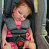 baby, sleeping, car_seat, gray, pink_clothing, pacifier, child, infant, safety_harness, cute, face, sticker, relaxation, indoors, transportation, seatbelt, toddler, resting, small_child, wearing_clothes