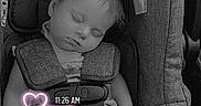 Phoenix is registered to the contest to win money with this photo: baby, car_seat, sleeping, child, infant, pacifier, straps, seatbelt, monochrome, neon, hearts, time_overlay, clothing, hair, face, relaxation, safety, cute, indoors, resting