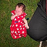Phoenix is registered to the contest to win money with this photo: baby, casual_clothing, child, cute, footwear, grass, human, infant, leg, nature, outdoor, peaceful, person, red_dress, relaxation, shoe, sleeping, summer, thumb_sucking, white_stars