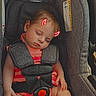 Phoenix is registered to the contest to win money with this photo: baby, car_seat, sleeping, child, infant, pink_clothing, stripes, harness, pacifier, seatbelt, safety, indoors, cute, peaceful, toddler, head, face, skin, resting, doodle