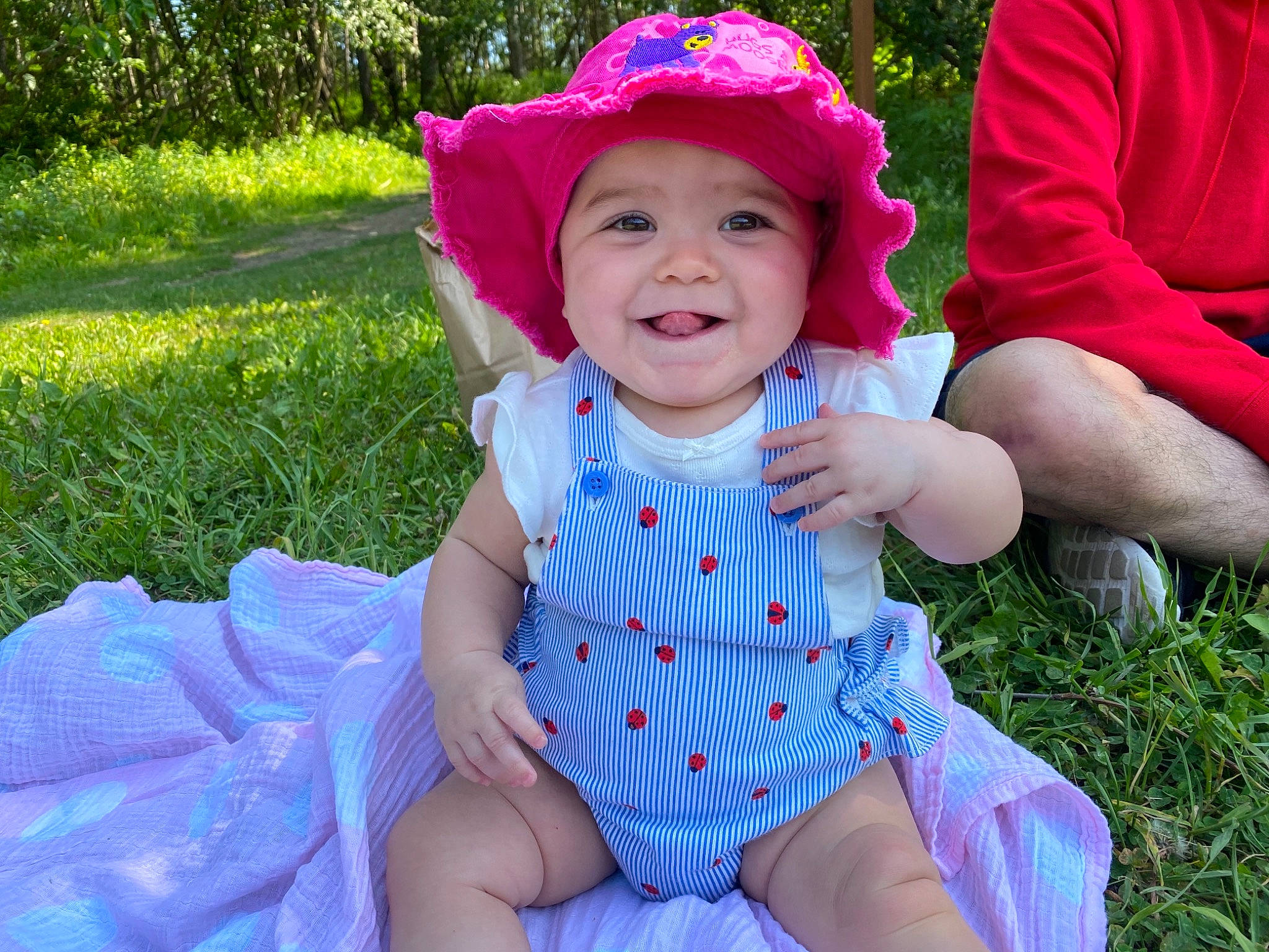 Ezlyn joined the competition — help win amazing prizes! baby, baby_toddler_clothing, bonnet, child, costume_accessory, costume_hat, fedora, garden, hat, headwear, human, joy, lap, overall, person, sitting, sock, sun_hat, toddler