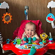 Bentleigh joined the competition — help win amazing prizes! baby, infant, smile, tongue_out, activity_center, toy, red_toy, teal_propeller, blanket, seat, play_toy, mirror_toy, cloud_toy, wooden_wall, carpet, hands, eyes, clothing, portrait, indoor