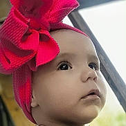 Dahlia is registered to the contest to win money with this photo: baby, child, portrait, face, headwrap, pink, bow, clothing, colorful, cute, closeup, young, person, expression, eyes, skin, indoors, fashion, adorable, infant