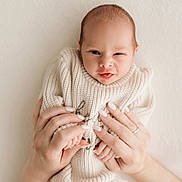 Aiden joined the competition — help win amazing prizes! baby, infant, hands, knitted_sweater, cozy, cute, tongue_out, newborn, soft_light, portrait, human, skin, fingers, nails, holding, expression, face, small, warm, gentle