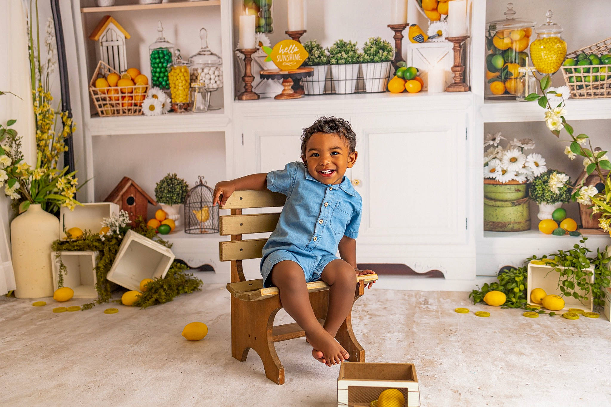 Kellan is registered to the contest to win money with this photo: child, floor, flooring, flowerpot, house, houseplant, interior_design, joy, leisure, living_room, orange, person, photograph, picture_frame, plant, shelf, shorts, snapshot, t_shirt, toddler
