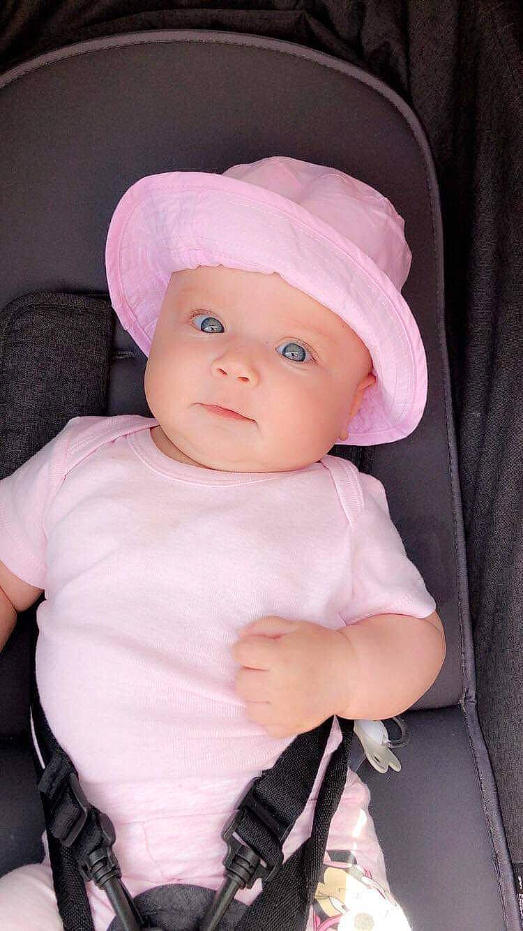 Chanel participe au concours pour gagner de l'argent avec cette photo : baby, baby_products, cheek, child, doll, fashion_accessory, hat, head, headgear, person, pink, product, skin, toddler