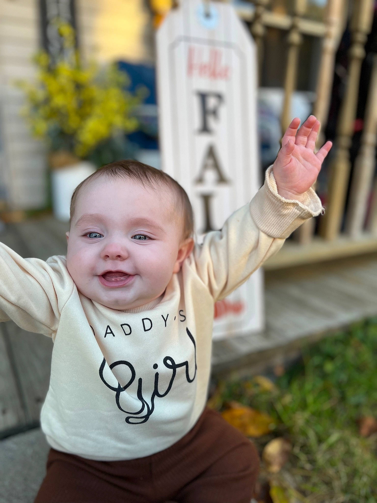 Braylyn is registered to the contest to win money with this photo: baby, baby_toddler_clothing, cheek, child, eye, facial_expression, finger, fun, gesture, grass, hair, hand, happy, joy, leisure, person, plant, sitting, sleeve, smile
