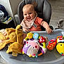Judith participe au concours pour gagner de l'argent avec cette photo : baby, bib, child, clothing, cute, expression, face, flooring, hand, happy, high_chair, indoor, infant, person, play, plush_toy, rattle, seat, smile, toy