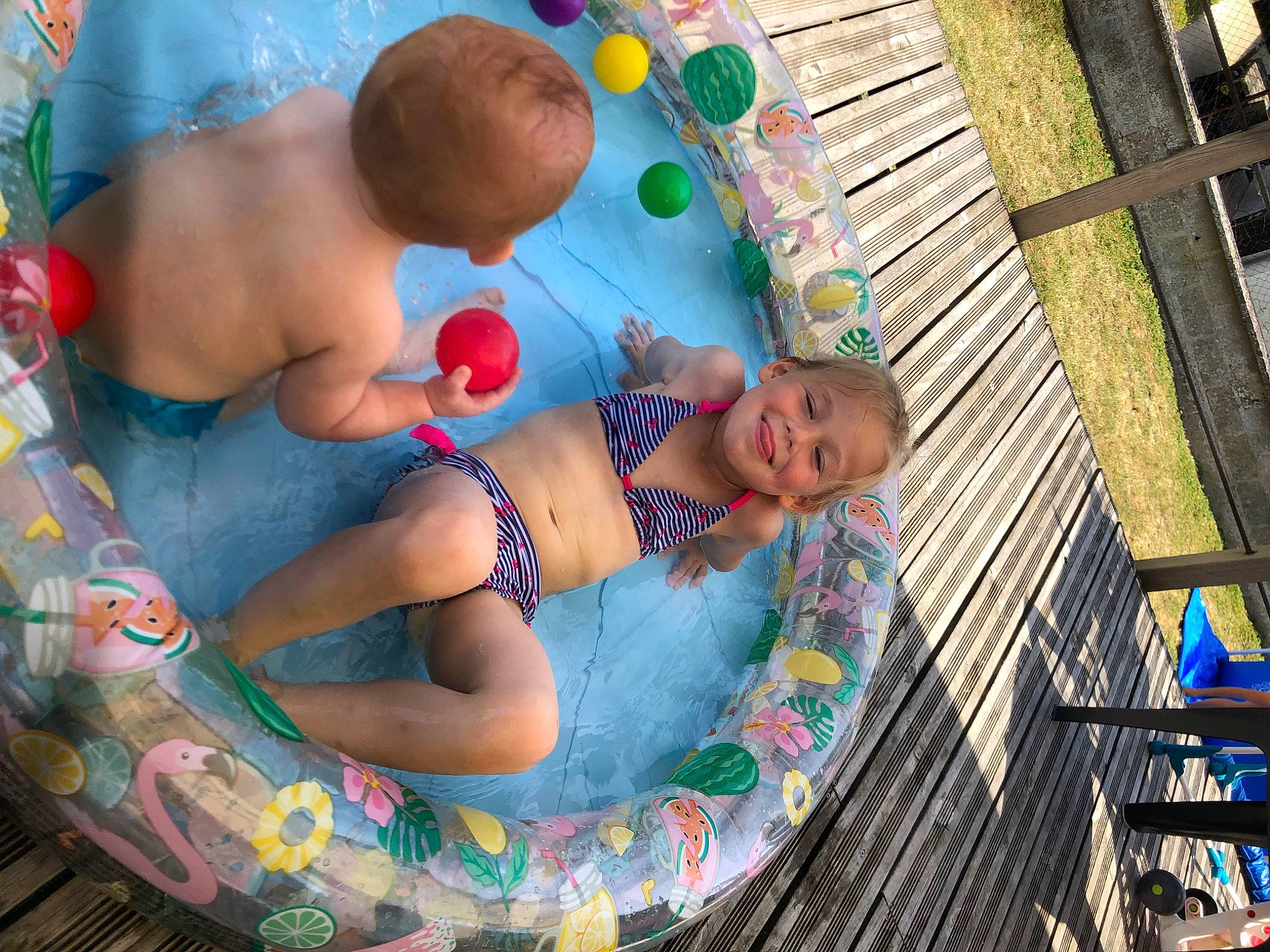 Léonie participe au concours pour gagner de l'argent avec cette photo : baby, bathing, blue, chest, child, fun, happy, joy, leisure, navel, pattern, people, person, recreation, sitting, smile, summer, swimwear, thigh, toddler