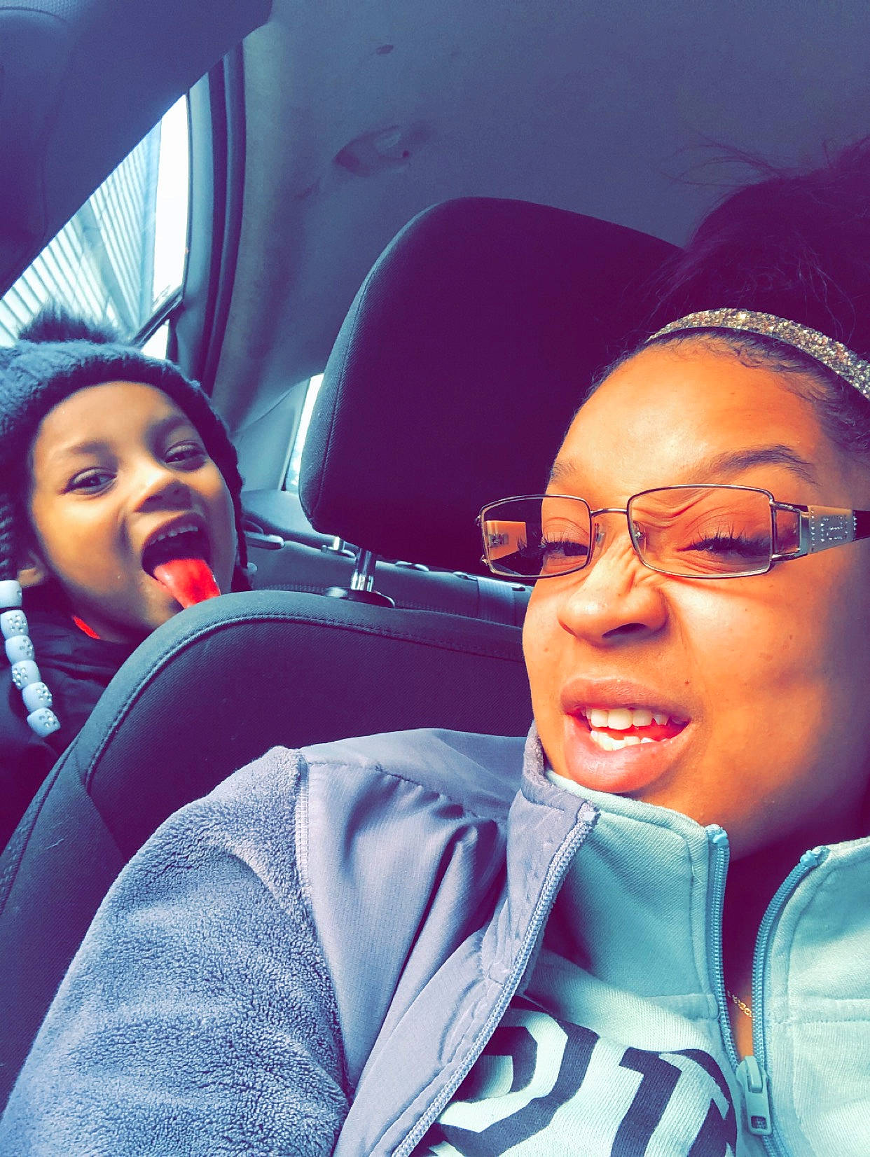 Sadie joined the competition — help win amazing prizes! black_hair, car_seat, car_seat_cover, comfort, cool, eyebrow, eyewear, glasses, head_restraint, headwear, hood, jacket, mouth, nose, passenger, person, seat_belt, tongue, tooth, vehicle_door