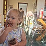 Lounah a rejoint le concours — aidez-le/la à gagner de superbes lots ! toddler, child, chocolate, messy, face, fingers, indoor, kitchen, table, chair, clothing, bottle, floor, light, window, curly_hair, person, smiling, eating, cup