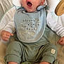 George joined the competition — help win amazing prizes! baby, infant, yawning, bib, green_clothing, ribbed_pants, pacifier, cushioned_seat, indoor, sleepy, cute, child, foot, hand, face, head, person, baby_outfit, soft_toys, relaxing