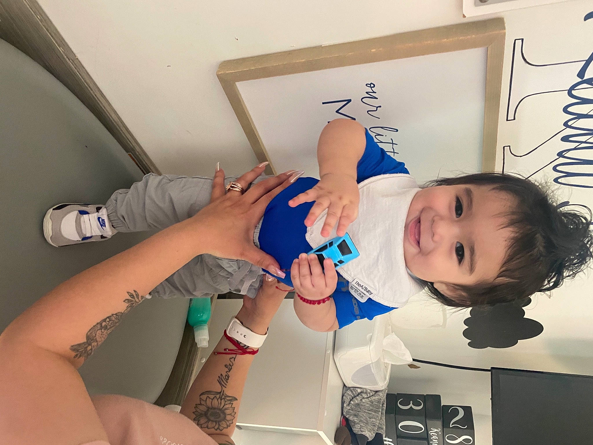 Keanu is registered to the contest to win money with this photo: arm, baby, dress, elbow, eyelash, finger, fun, gesture, hand, happy, hat, human_body, human_leg, joy, knee, leg, mouth, person, skin, smile