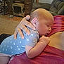 Maddie is registered to the contest to win money with this photo: baby, sleeping, onesie, hand, person, indoor, couch, furniture, carpet, dresser, fireplace, relaxing, cozy, infant, home, comfort, nap, skin, clothing, peaceful
