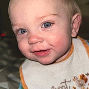 Scout joined the competition — help win amazing prizes! baby, child, face, blue_eyes, smile, bib, thanksgiving, clothing, toddler, indoor, portrait, cute, happy, infant, close_up, hair, skin, person, apparel, expression