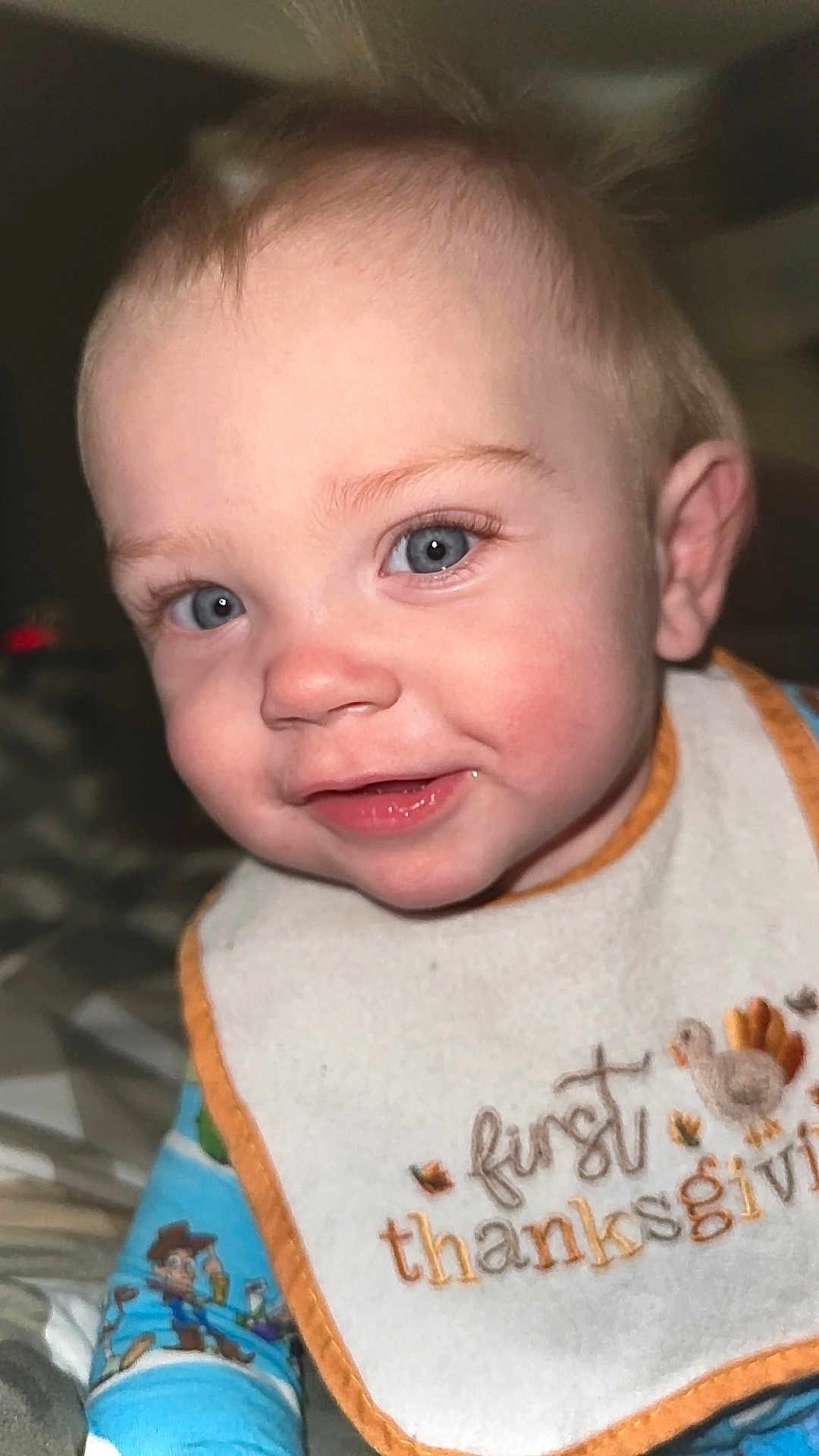 Scout joined the competition — help win amazing prizes! baby, child, face, blue_eyes, smile, bib, thanksgiving, clothing, toddler, indoor, portrait, cute, happy, infant, close_up, hair, skin, person, apparel, expression