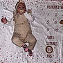 Iris participe au concours pour gagner de l'argent avec cette photo : baby, infant, pacifier, blanket, milestone, clothing, headband, socks, lying_down, child, face, pink, beige, stars, numbers, text, cute, indoors, portrait, soft_texture