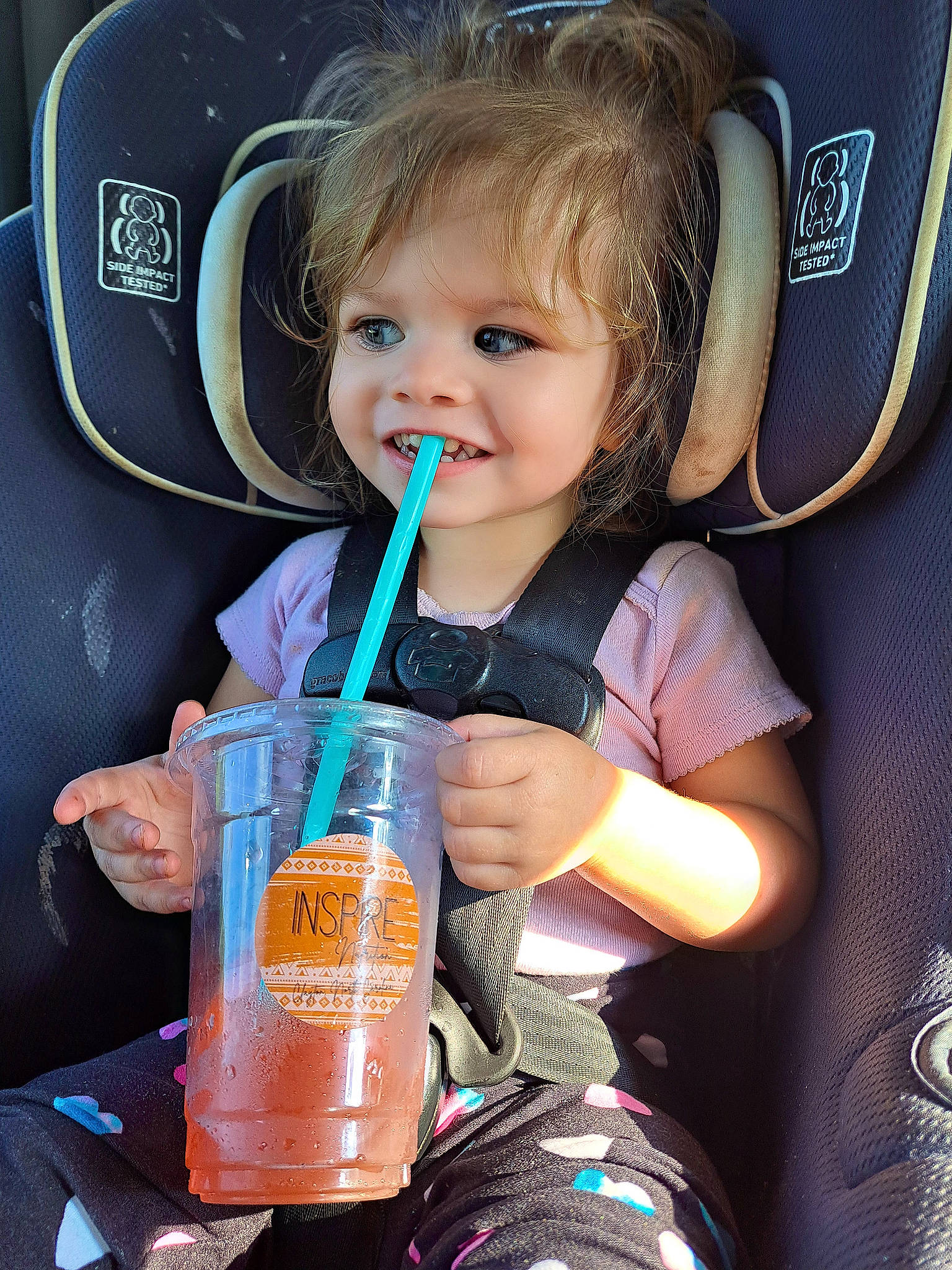 Skyler is registered to the contest to win money with this photo: auto_part, baby, baby_products, baby_toddler_clothing, blond, car_seat, child, drink, drinking, drinkware, fun, happy, joy, person, plastic, plastic_bottle, product, skin, smile, steering_wheel