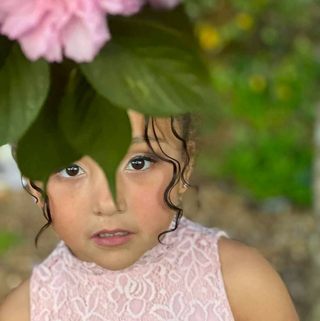 Abigail is registered to the contest to win money with this photo: annual_plant, close_up, doll, eye, eyelash, face, fashion_accessory, flower, flowering_plant, grass, hair_accessory, happy, headpiece, headwear, iris, lip, people_in_nature, person, petal, plant