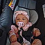 Raven joined the competition — help win amazing prizes! baby, pacifier, car_seat, pink_clothing, headband, infant, child, safety_harness, cute, relaxed, indoors, seat_belt, small_hands, infant_clothing, soft_cushion, young_child, baby_gear, toddler, child_seat, baby_accessory