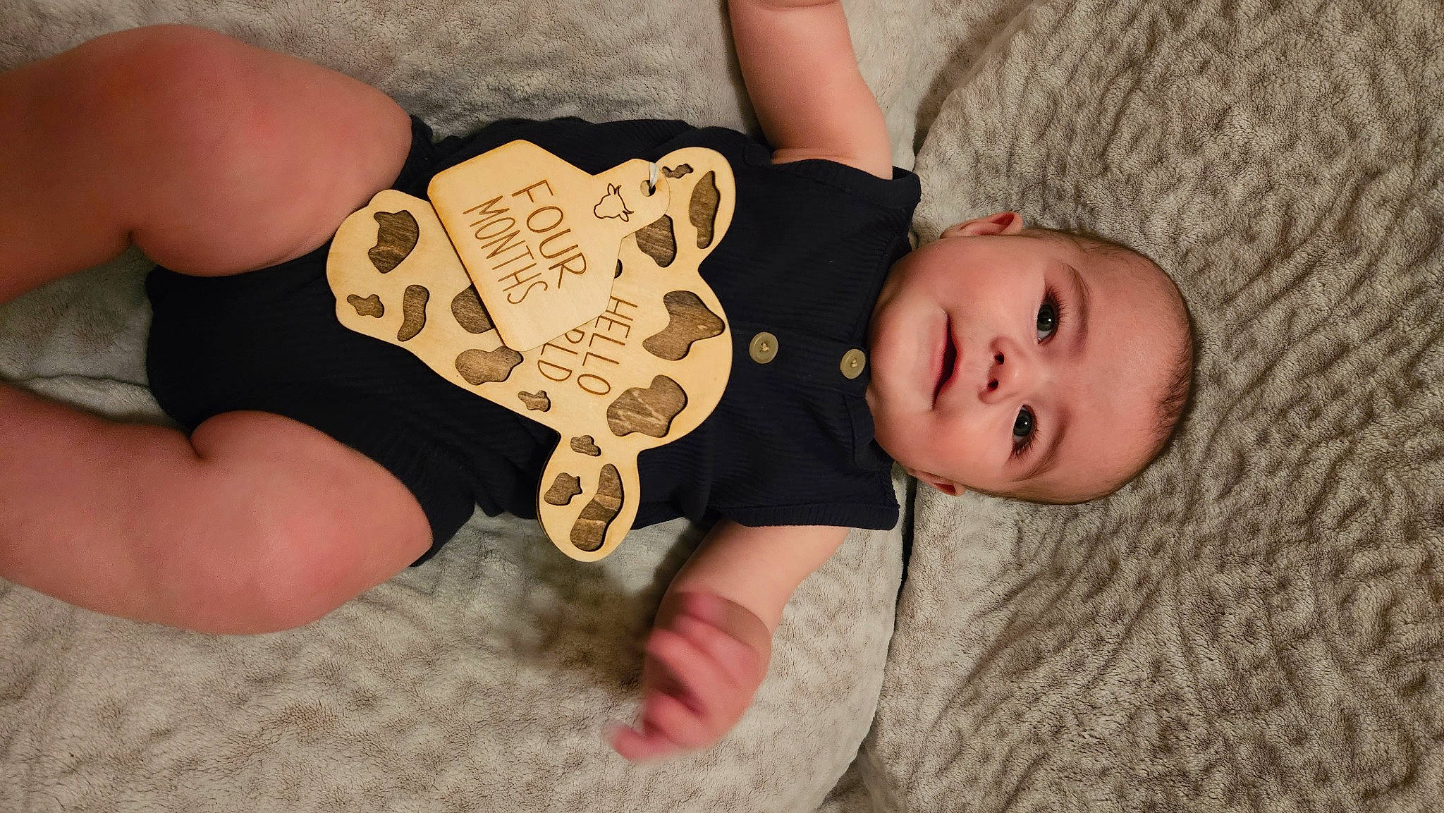 Kasey joined the competition — help win amazing prizes! baby, baby_toddler_clothing, child, comfort, eye, finger, flooring, foot, human_leg, knee, linens, nail, pattern, person, sitting, sleeve, thigh, thumb, toddler, wood